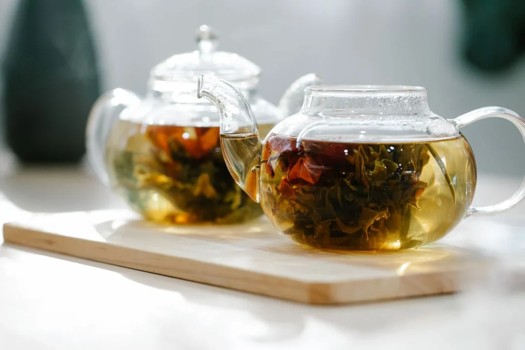 Adding black tea bags and dark brown sugar to the steeped spiced infusion off heat