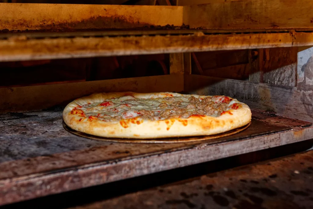 Baking flatbread pizza in the oven until mozzarella is golden and bubbling
