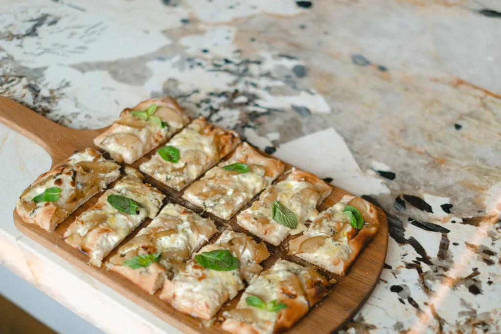 Ingredients for tandoori chicken flatbread pizza laid out on a kitchen counter