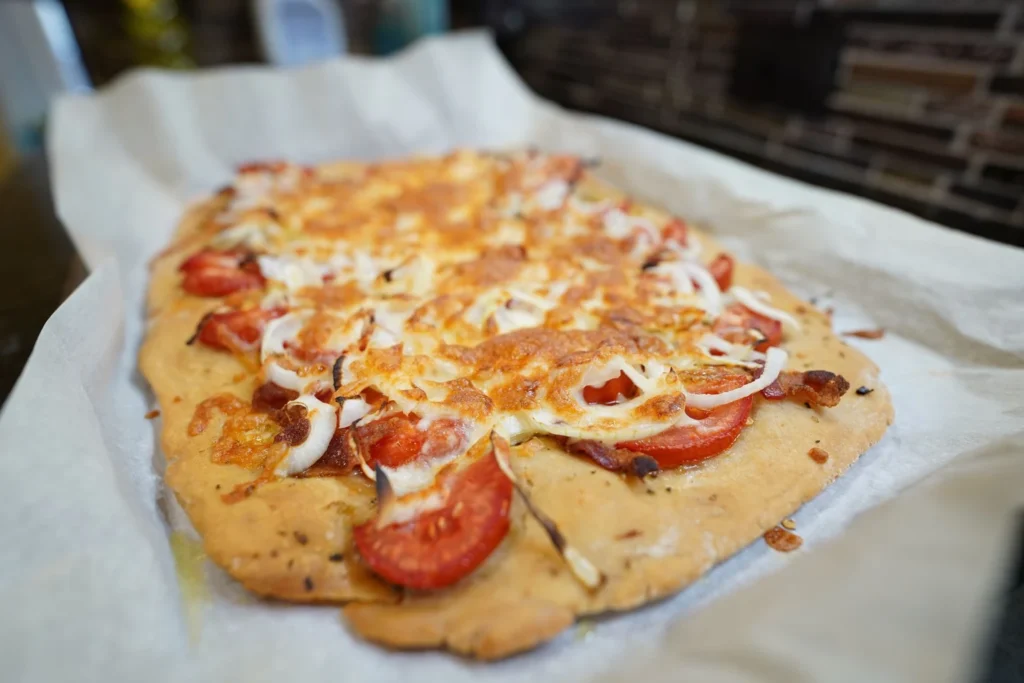 Pre-toasting naan flatbreads on a baking sheet until warm and crisp