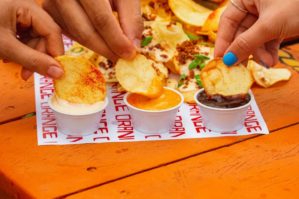 Crispy smashed potato dipped into fresh cilantro-mint crema