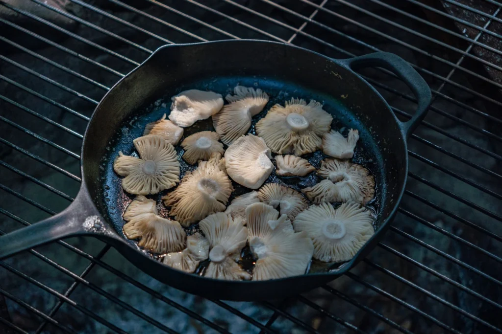 Searing cremini mushrooms in ghee over high heat until browned