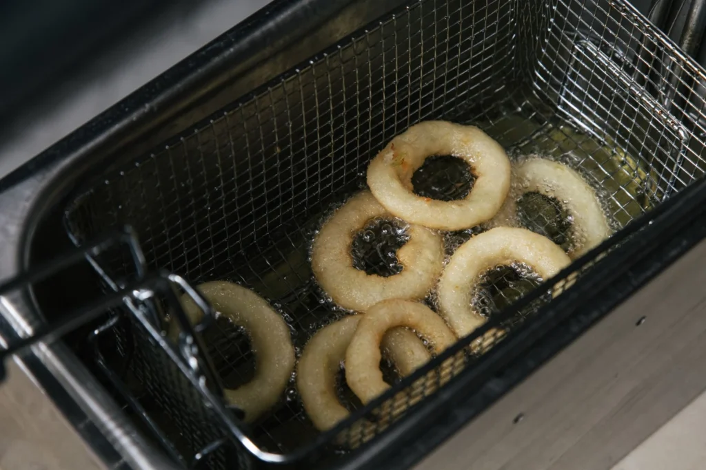 Air-frying onion bhaji fritters until golden-brown and crisp