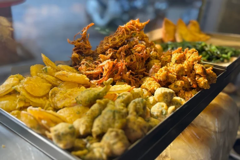 Crispy air-fried onion bhaji fritters stacked with lemon wedges