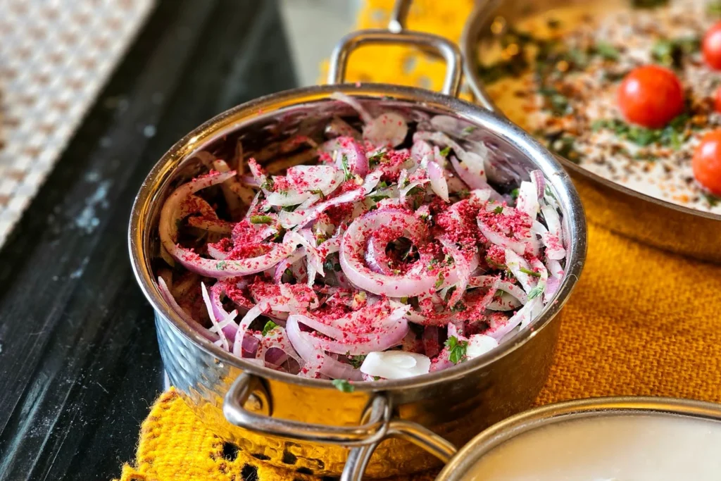 Thinly sliced onions, chickpea flour, and whole spices for onion bhaji