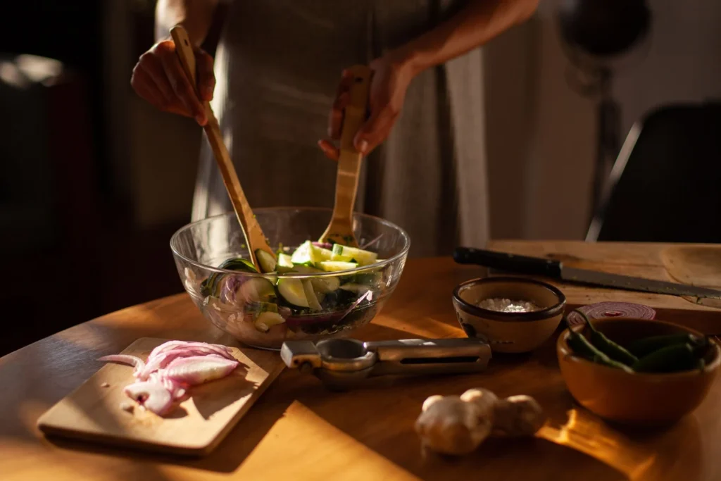 Massaging salted sliced onions until soft and naturally moist