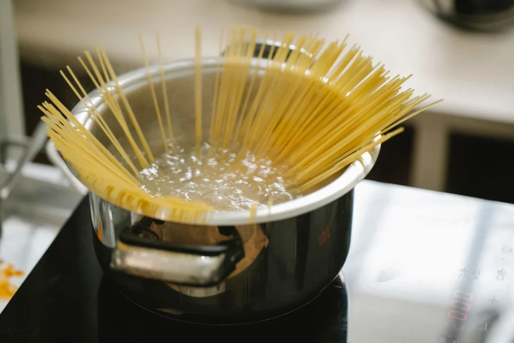 Boiling penne pasta in a salted pot of water
