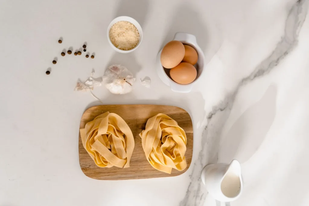 Ingredients for butter chicken pasta laid out on a kitchen counter