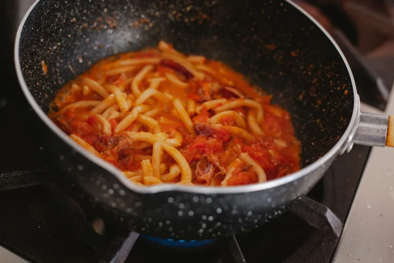 Simmering rich creamy butter chicken sauce in a large skillet