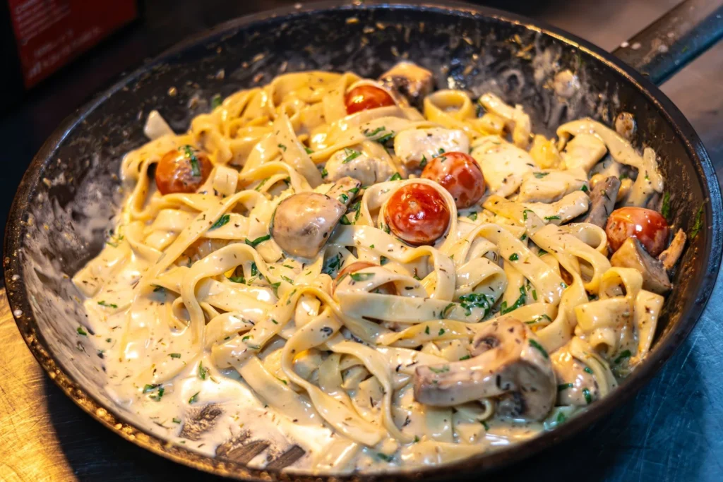 Tossing penne pasta and chicken into the velvety butter chicken sauce