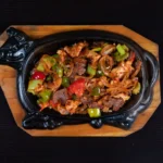 Vibrant paneer jalfrezi stir-fry with colorful bell peppers in a skillet
