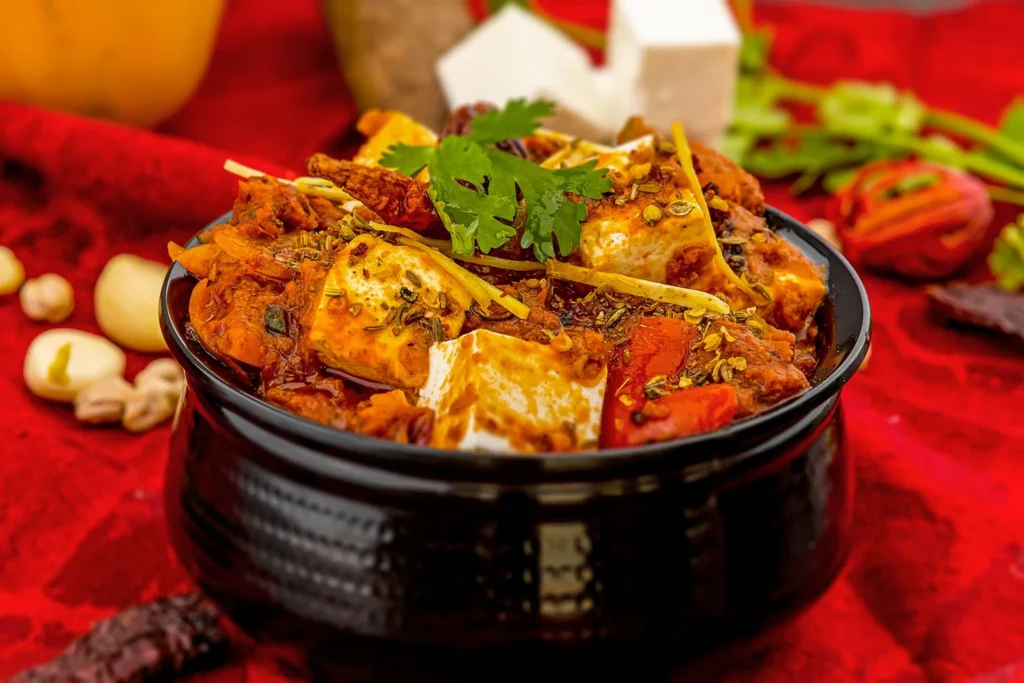 Folding paneer batons into the glossy vegetable stir-fry