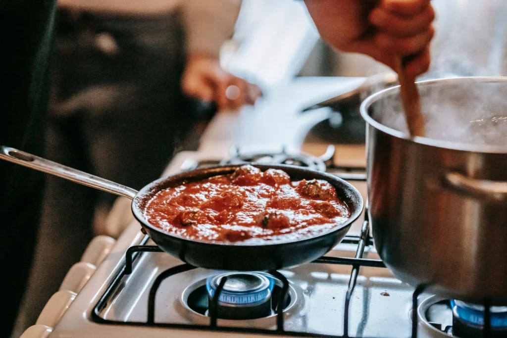 Adding turkey meatballs into the sweet and spicy tikka glaze