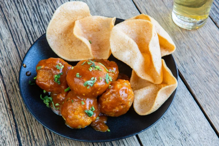 Glazed cocktail turkey meatballs on a serving platter with toothpicks