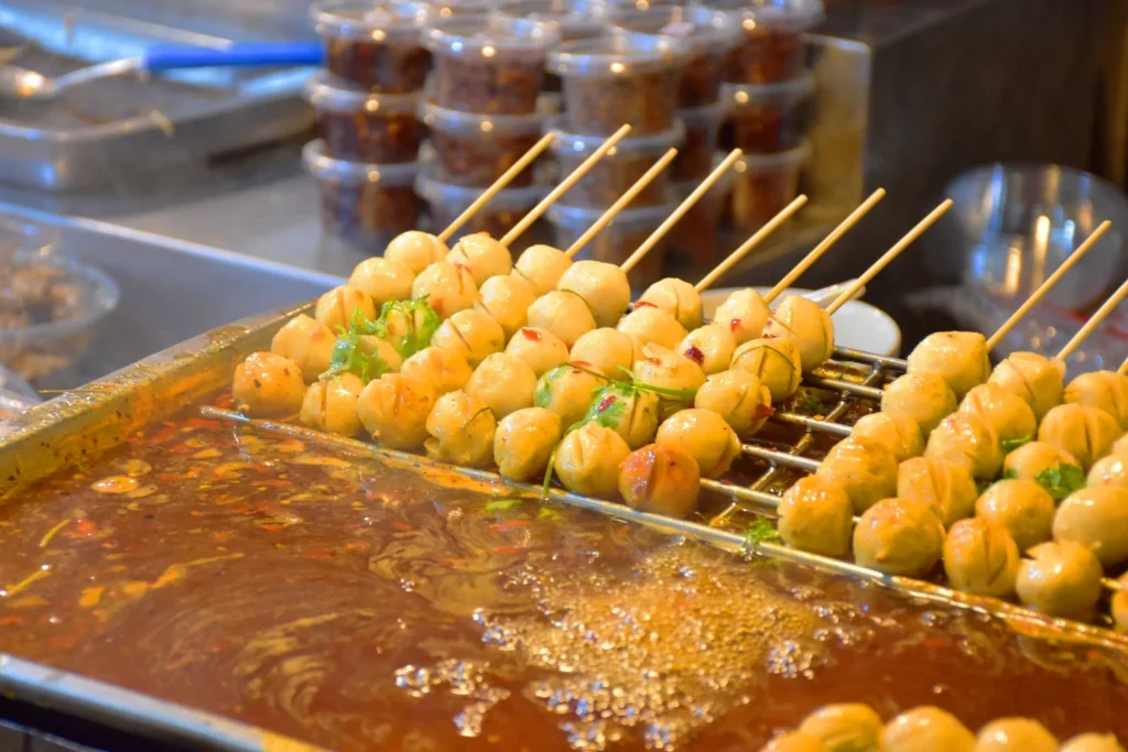 Simmering meatballs until sauce reduces into a thick clinging lacquer