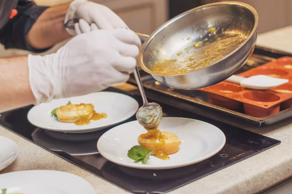 Whisking honey and tikka masala sauce in a skillet